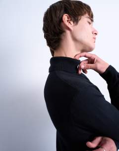 Model wearing Essential roll neck with wool in black