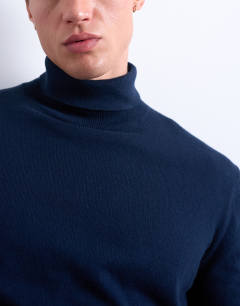 Model wearing Essential roll neck with wool in navy