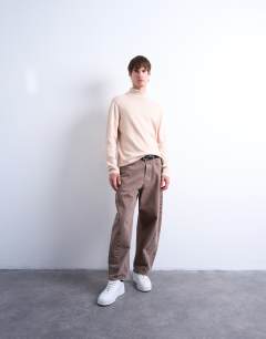 Model wearing Essential roll neck with wool in stone