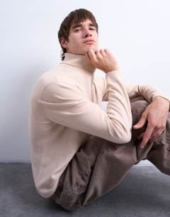 Model wearing Essential roll neck with wool in stone