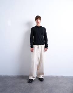 Model wearing Essential zip polo with wool in black