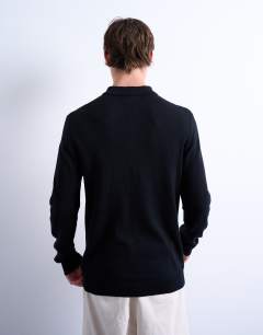 Model wearing Essential zip polo with wool in black