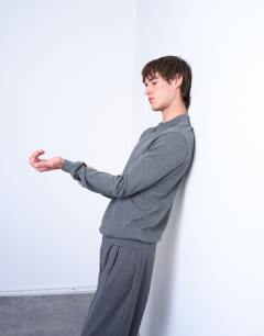Model wearing Essential zip polo with wool in charcoal