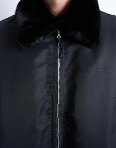 Model wearing Faux fur collar bomber jacket in black