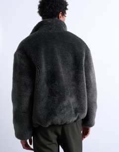 Model wearing Faux fur funnel neck jacket in dark grey