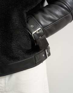 Model wearing Faux shearling jacket in black