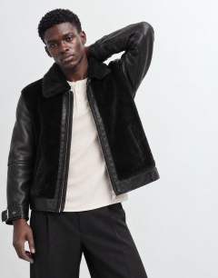 Model wearing Faux shearling jacket in black
