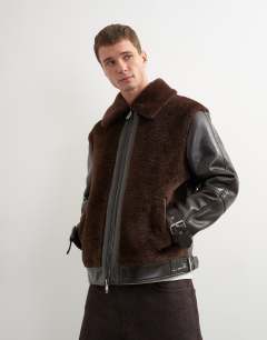 Model wearing Faux shearling jacket in chocolate brown