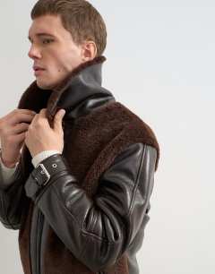 Model wearing Faux shearling jacket in chocolate brown
