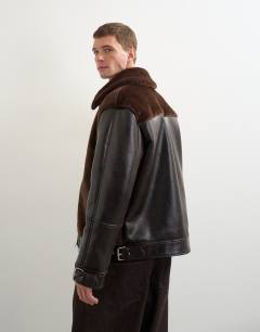 Model wearing Faux shearling jacket in chocolate brown