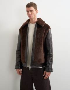 Model wearing Faux shearling jacket in chocolate brown