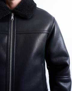 Model wearing Faux shearling jacket with zip pockets in black