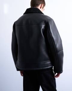 Model wearing Faux shearling jacket with zip pockets in black