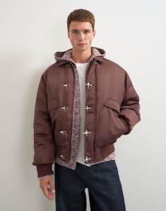 Model wearing Fireman clasp padded bomber jacket in burgundy