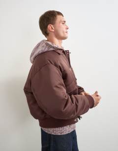 Model wearing Fireman clasp padded bomber jacket in burgundy