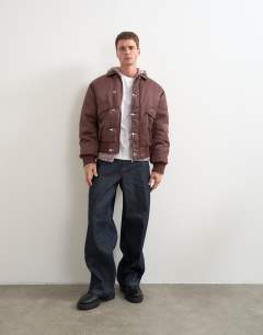 Model wearing Fireman clasp padded bomber jacket in burgundy