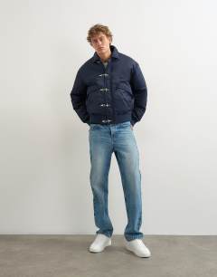 Model wearing Fireman clasp padded bomber jacket in navy