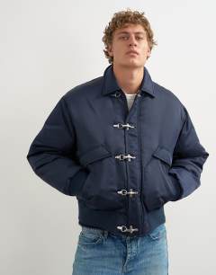 Model wearing Fireman clasp padded bomber jacket in navy