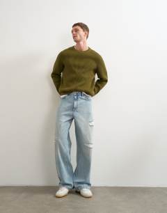 Model wearing Fisherman rib knitted jumper in khaki