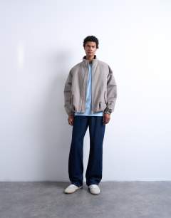 Model wearing Funnel neck check track jacket in brown