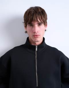 Model wearing Half zip funnel scuba-style fabric pullover in black