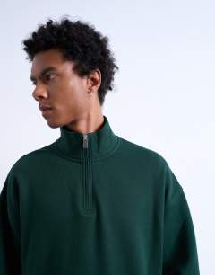 Model wearing Heavyweight oversized fit 1/4 zip in pine green