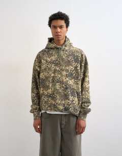 Model wearing Heavyweight oversized fit camo print hoodie in green