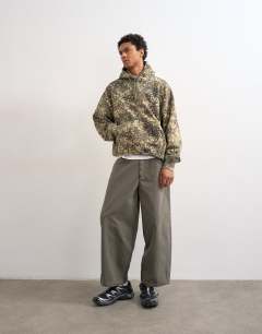 Model wearing Heavyweight oversized fit camo print hoodie in green