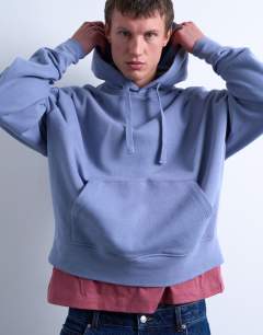 Model wearing Heavyweight oversized fit hoodie in mid blue