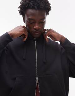 Model wearing Heavyweight oversized fit zip through hoodie in black