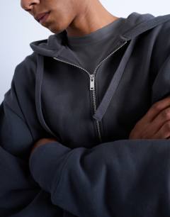 Model wearing Heavyweight oversized zip through hoodie in charcoal