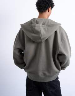 Model wearing Heavyweight oversized zip through hoodie in olive