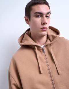 Model wearing Heavyweight oversized zip through hoodie in stone