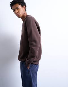 Model wearing Heavyweight raglan sweatshirt with raw seam in brown