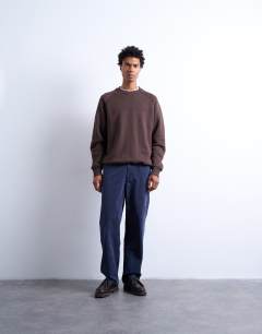 Model wearing Heavyweight raglan sweatshirt with raw seam in brown