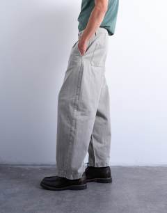 Model wearing Herringbone barrel trouser in stone