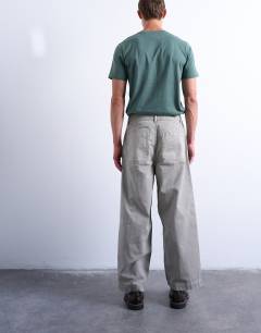 Model wearing Herringbone barrel trouser in stone