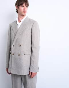 Model wearing Herringbone double breasted blazer in stone