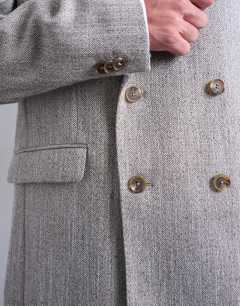 Model wearing Herringbone double breasted blazer in stone