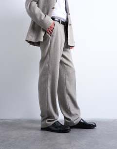 Model wearing Herringbone relaxed trousers in stone