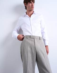 Model wearing Herringbone relaxed trousers in stone