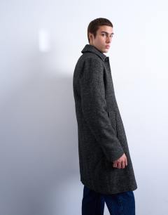 Model wearing Herringbone wool blend overcoat in black