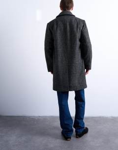 Model wearing Herringbone wool blend overcoat in black