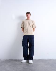 Model wearing Interlock relaxed fit t-shirt in stone
