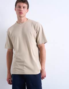 Model wearing Interlock relaxed fit t-shirt in stone