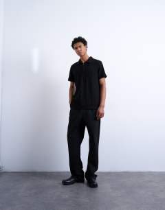 Model wearing Jersey zig zag polo top in black