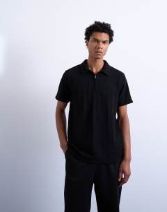 Model wearing Jersey zig zag polo top in black