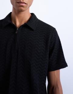 Model wearing Jersey zig zag polo top in black