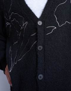 Model wearing Knitted cardigan with floral embroidery in black