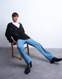 Model wearing Knitted cardigan with floral embroidery in black